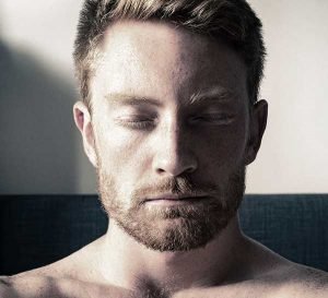 Depressed man with eyes closed