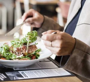 Close up of businessman eating a dish in a restaurant